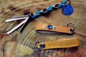 ビオスの丘のかんたん革細工体験で完成した、本革の編み紐キーホルダーと刻印入りレザータグ。